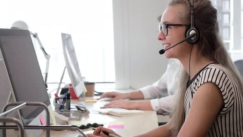 Businesswoman telemarketer talking with customer in call center office