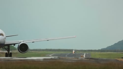 Airplane Landing on Airport Runway in Daytime