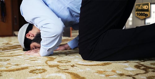 Man Bowing in Prayer on Rug