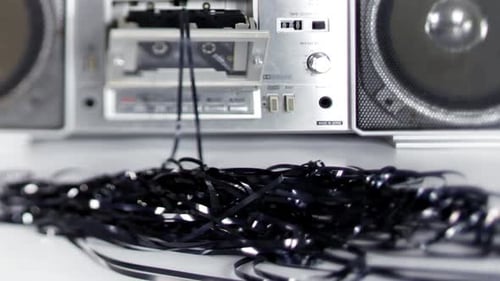 Damaged Cassette Tape and Retro Boombox