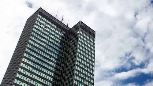 Reflections Of Clouds Moving In Glass Mirrored Office Tower