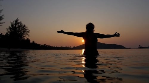 Free And Happy Woman In The Sea At Sunset