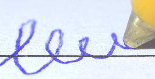 Pen Writing on Paper in Blue Ink