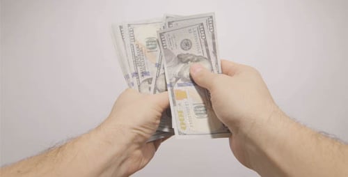 Counting stack of One Hundred Dollar Bills