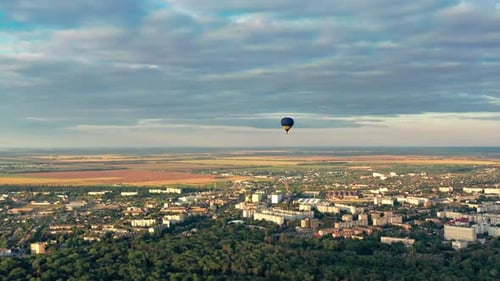 Aerial View of City With Hot Air Balloon