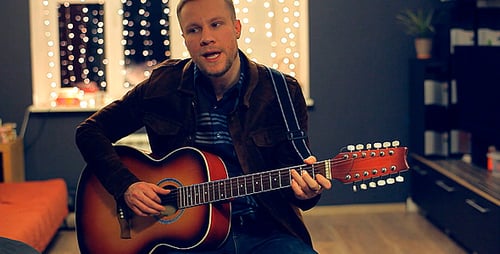 Man Plays Guitar and Sings a Song