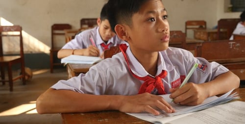Students Writing in Classroom at School