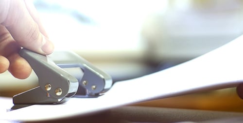 Office Worker Using A Puncher