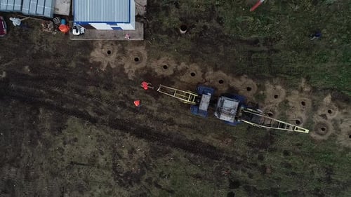 Top View of a Construction Site with Heavy Drill and Workers
