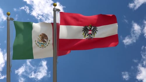 Waving Flags of Mexico and Austria Against Blue Sky