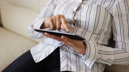 Adult Using Tablet at Home on Couch