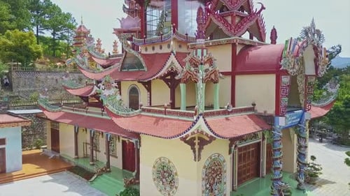 Drone Flies Around Decorated Temple Roof Among Buildings