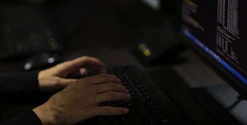 Hands Typing Code on a Computer Keyboard