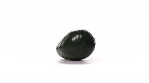 One Green Avocado Spinning on White Background