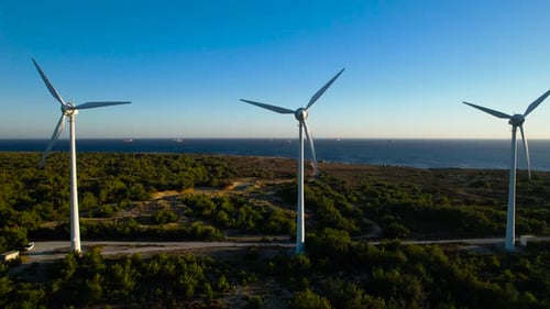 Wind turbines against the sea.