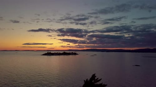 Reveal of Pine Tree Silhouettes just after Epic Sunset, Drone Aerial Wide Dolly Out. Clouds in Color