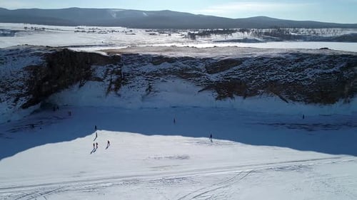 Aerial View of an Island in Frozen Lake Baikal with Many People Walking Around