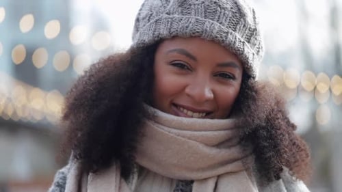 Happy African American Woman is Posing with Toothy Smile Standing on Street with Lights Spbi