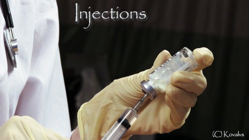 Doctor Filling Syringe with Medicine from Vial