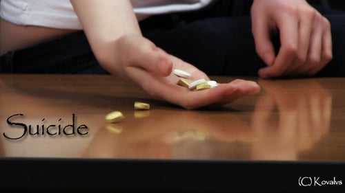 Hand Holding Yellow and White Pills