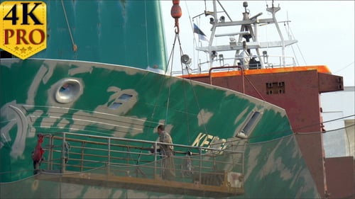 A Ship Worker Repainting Some Green Parts