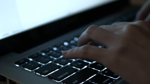 Hands Typing on Laptop Keyboard Close Up