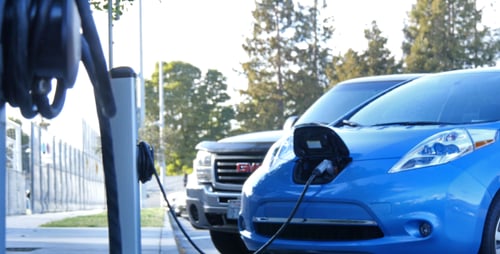 Electric Cars Charging at Station in Urban Area