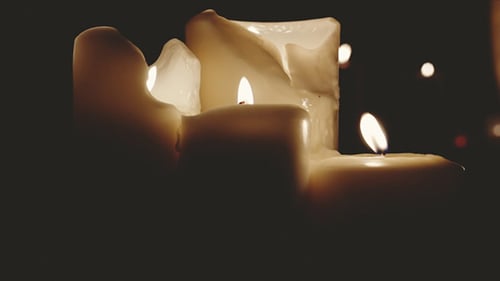 Close Up of Candles Burning in Darkness