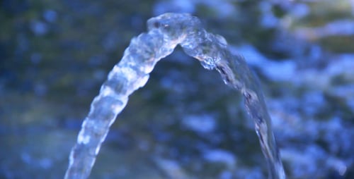 Arched Clear Water Flowing From Fountain