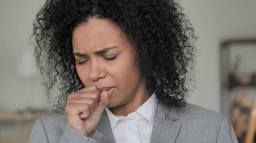 Young Adult Woman Coughing into Fist Close Up
