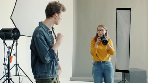 Photographer Taking Pictures of Model in Studio