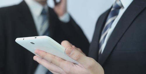 Businessmen Using Tablet and Talking on the Phone