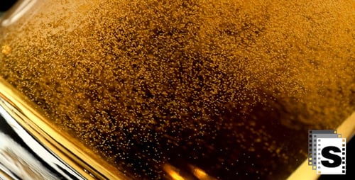 Beer Pouring into Glass with Bubbles Close Up