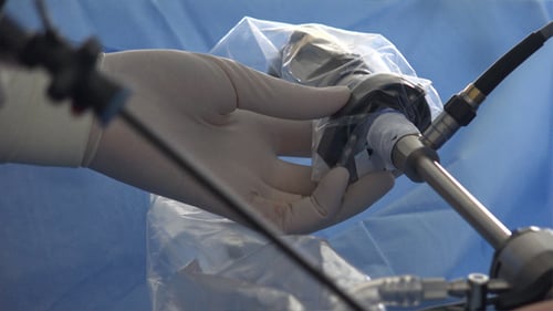 Gloved Hand Using Advanced Surgical Instrument