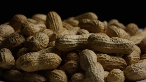 Cinematic, rotating shot of peanuts on a white surface - PEANUTS 028