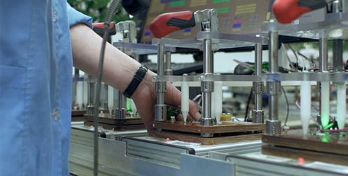 Worker Assembling Electrical Circuit Board in Factory