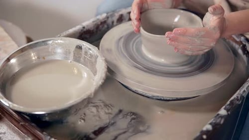 Close-up View of Hands of Woman Producing Clay Bowl on Potter's Wheel