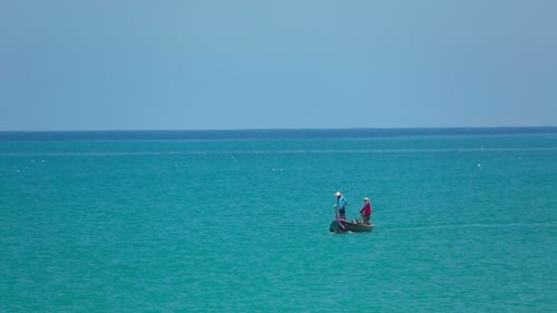 Long Boat Sailing on Turquoise Tropical Sea