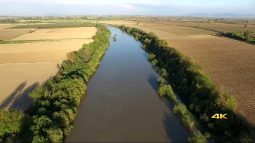 Aerial View Flying Over River and Plain Fields 1