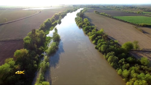 Aerial View Flying Over River and Plain Fields 2