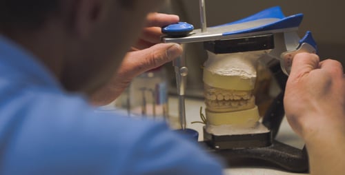 Dental Technician Working on Tooth Molds