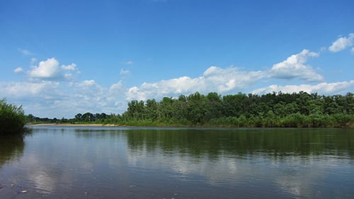 Landscape With River And Rain On Horizon