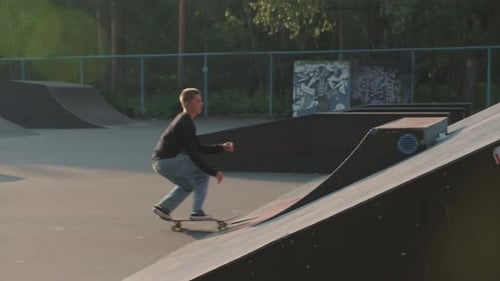 Guy Skating on Ramp in Skatepark