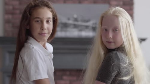 Two Girls Smiling Together Indoors