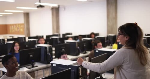 Young students using computers at school class