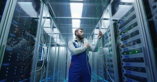 Male Technician Working in a Data Center