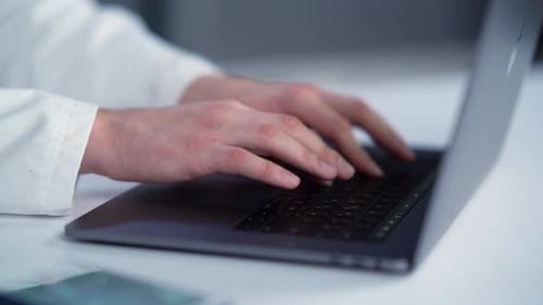 Close Up of Typing on Laptop in Lab