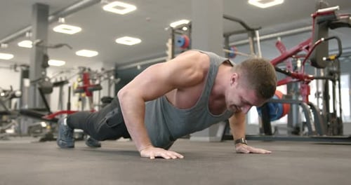 Athletic Man Doing Push Ups at Modern Gym