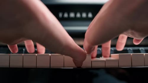 Close-up: a woman sensually plays the piano
