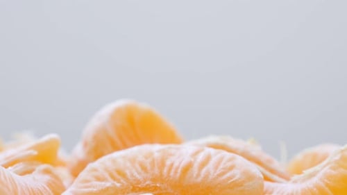 Juicy orange peeled off on white surface slow tilting 4K 2160p 30fps UltraHD video - Healthy Citrus